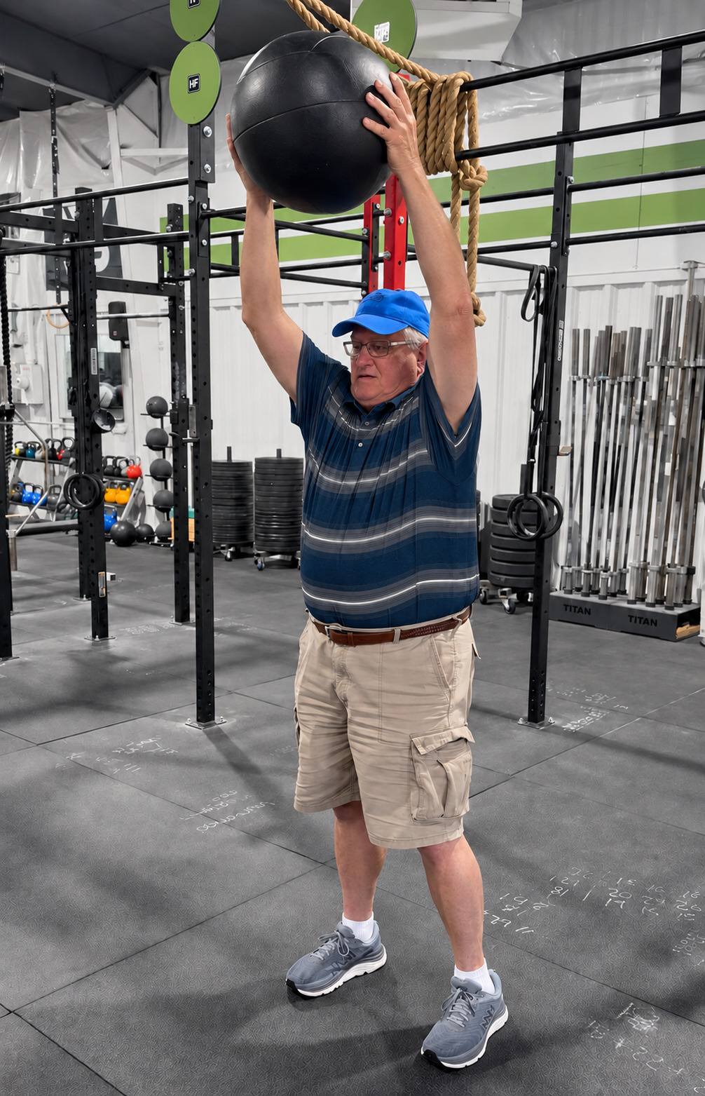 An adult golfer completing an overhead medicine-ball exercise