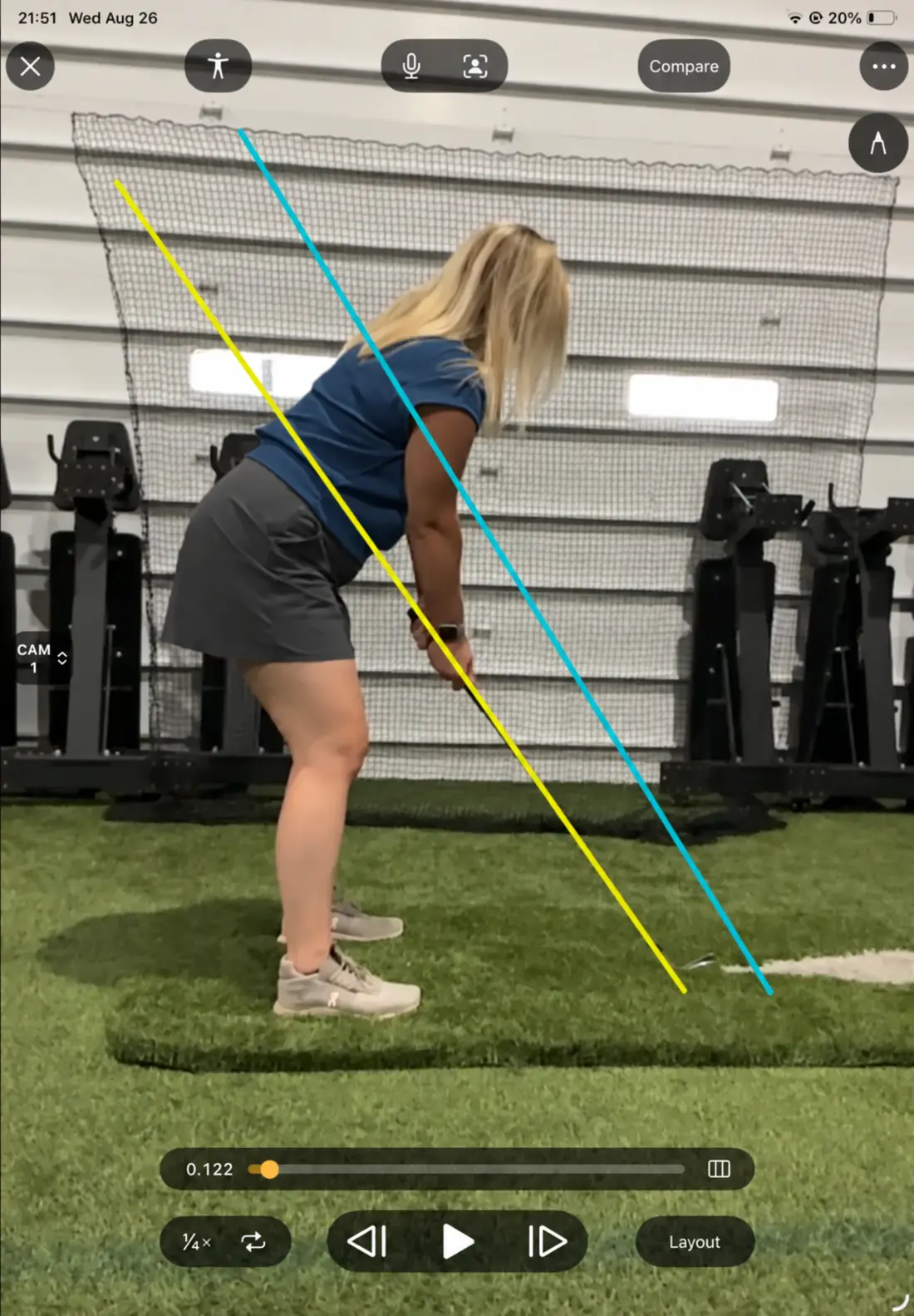 A golfer at address during video swing analysis with alignment lines
