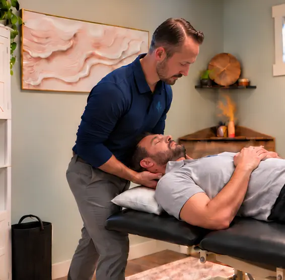 Michael Donohue, PT, DPT providing hands-on neck treatment to a patient