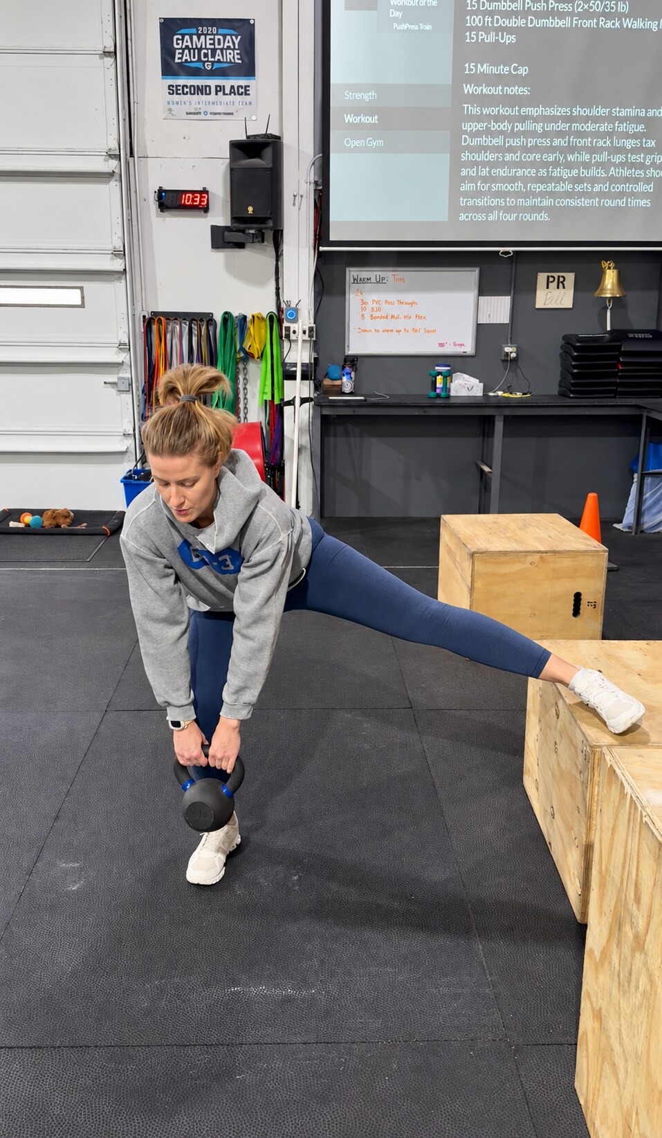 An active adult performing a kettlebell-supported mobility and strength exercise